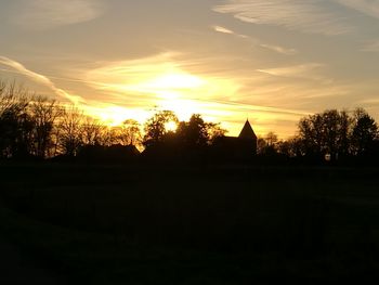 Silhouette trees against sky during sunset