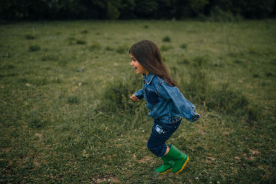 Side view of woman standing on field