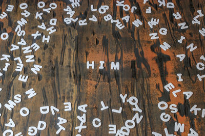 Full frame shot of alphabets on wooden table