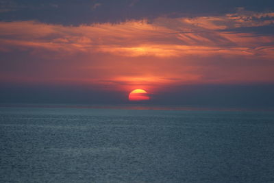 Scenic view of sea against romantic sky at sunset