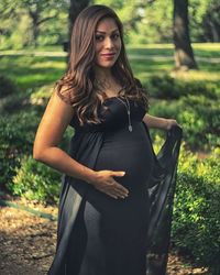 Portrait of beautiful woman standing in park