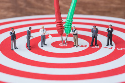 Close-up of figurines on dartboard