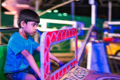 Boy sitting in ride night