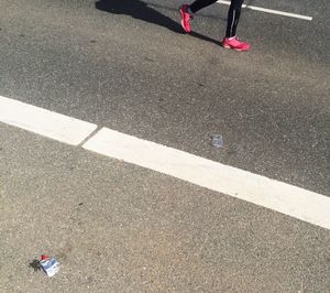 Low section of woman walking on zebra crossing