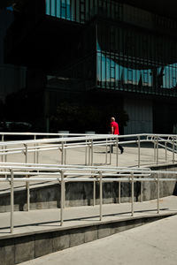 Rear view of man standing on escalator
