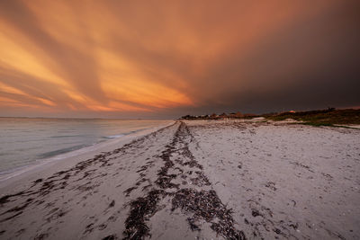 Scenic view of beach against sky during sunset