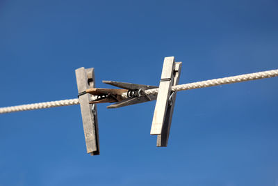 Low angle view of cross against clear blue sky