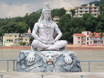 Statue against fountain