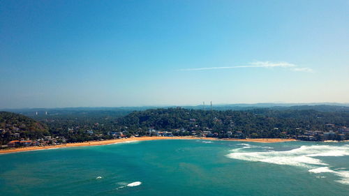 Scenic view of sea and city against sky