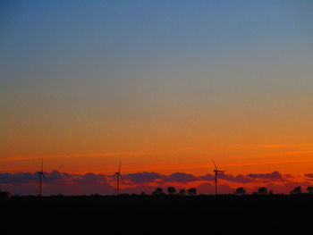 Scenic view of silhouette field against romantic sky at sunset