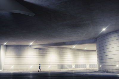 Man walking in illuminated tunnel