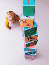High angle view of boy holding toy over white background