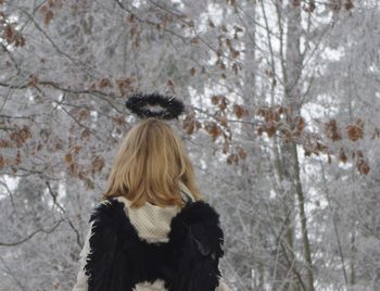 Woman on snow covered tree