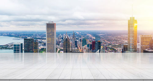 Modern buildings in city against cloudy sky