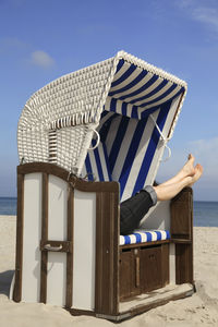 Lifeguard hut on beach against clear blue sky