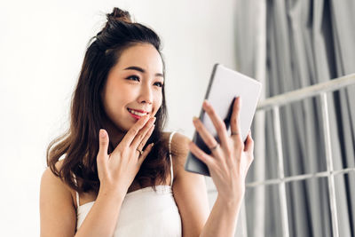 Portrait of young woman using mobile phone