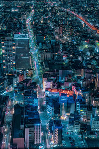 High angle view of city lit up at night