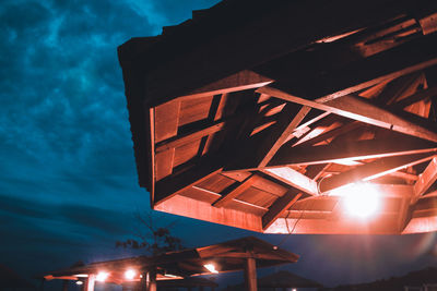 Low angle view of illuminated building against sky at night