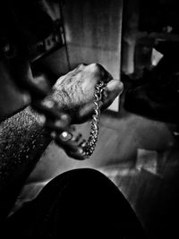 Close-up of human hand holding metal