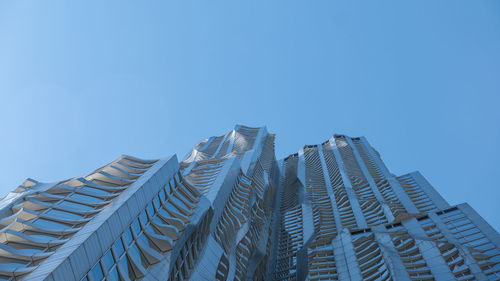 Low angle view of modern buildings against clear blue sky