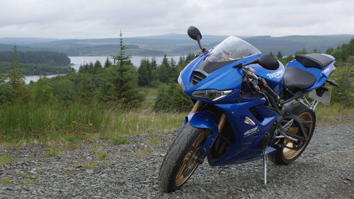 Motorcycle on field against sky