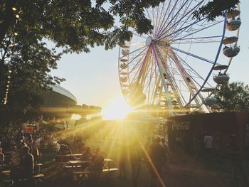 Ferris wheel against sky on sunny day