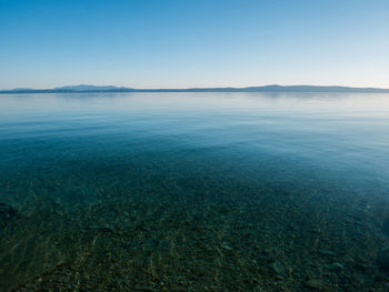 Scenic view of sea against clear blue sky