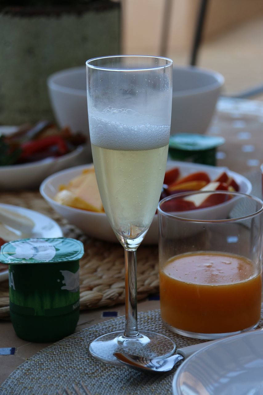 food and drink, drink, refreshment, freshness, table, drinking glass, indoors, still life, close-up, focus on foreground, frothy drink, coffee - drink, serving size, restaurant, alcohol, healthy eating, juice, saucer, glass, food