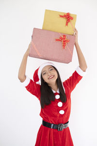 Full length of a smiling girl standing against white background