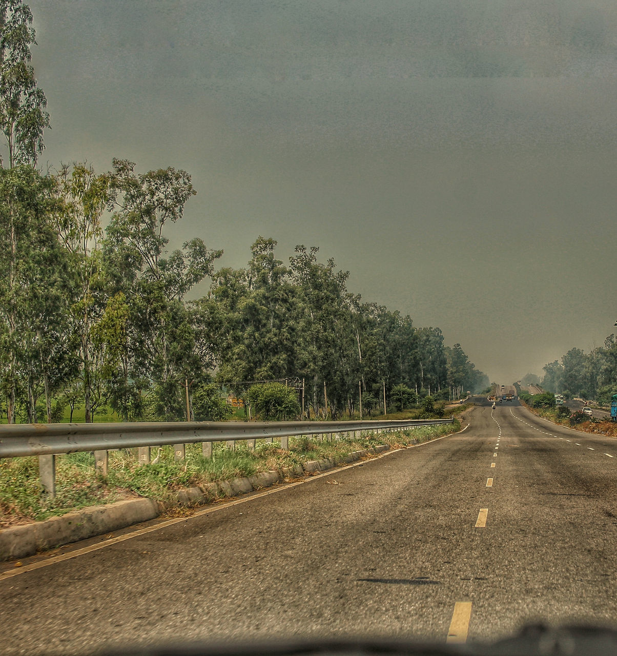 ROAD SEEN THROUGH CAR WINDSHIELD