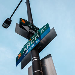 Low angle view of road sign against sky