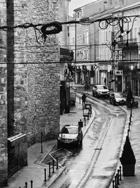 Cars on street by buildings in city