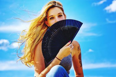 Portrait of woman against blue sky