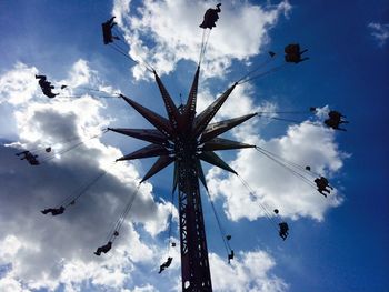 Low angle view of amusement park ride against sky