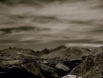 Scenic view of mountains against cloudy sky