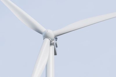 Low angle view of wind turbine against clear sky