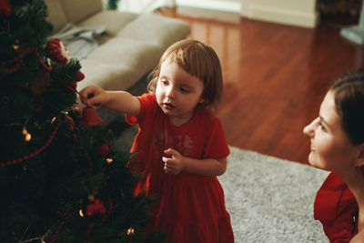 High angle view of girl playing with christmas tree