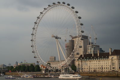 Ferris wheel in city against sky