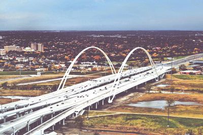 High angle view of bridge and cityscape against sky