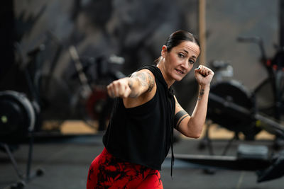 Young woman exercising in gym