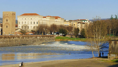 Buildings in city against blue sky