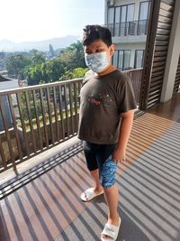 High angle view of boy standing with mask