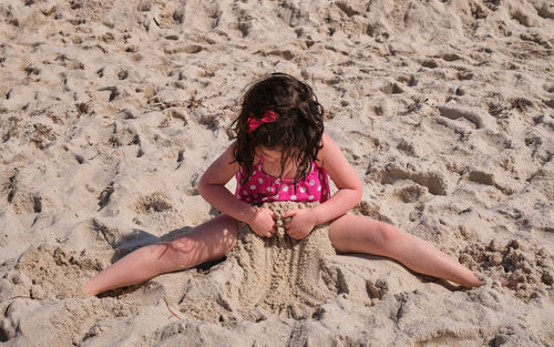 Cute young girl playing and fooling around at the beach