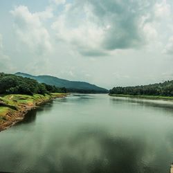 Scenic view of lake against cloudy sky