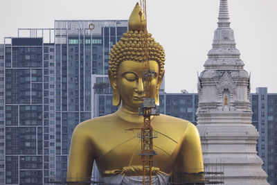 Statue of temple against building