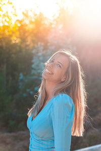 Portrait of a smiling young woman standing outdoors