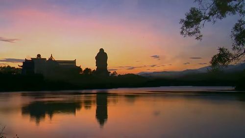 Scenic view of lake against orange sky
