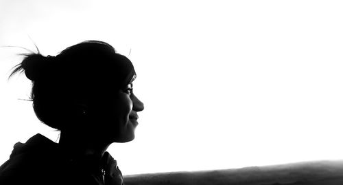Side view of silhouette boy against clear sky