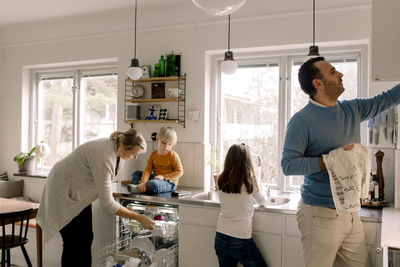 Family working in kitchen at home