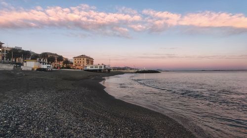 Scenic view of beach against sky during sunset
